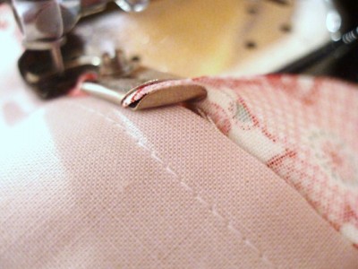 Bias is fed, folded, stitched and bound in place