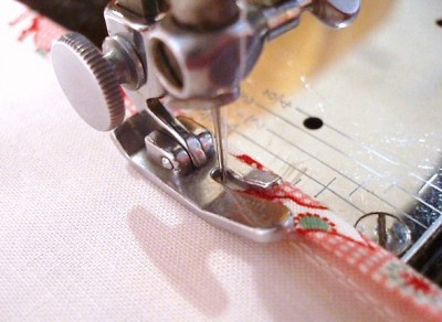 Stitching the bias-binding in place.